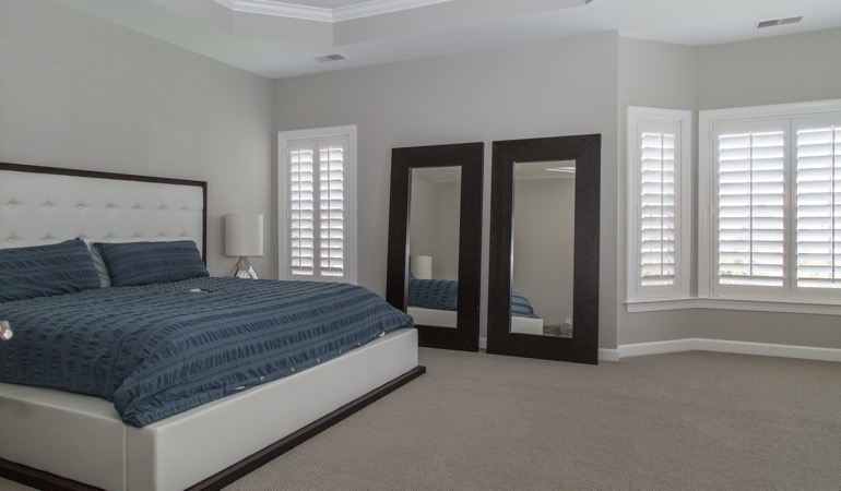 Polywood shutters in a minimalist bedroom in Indianapolis.